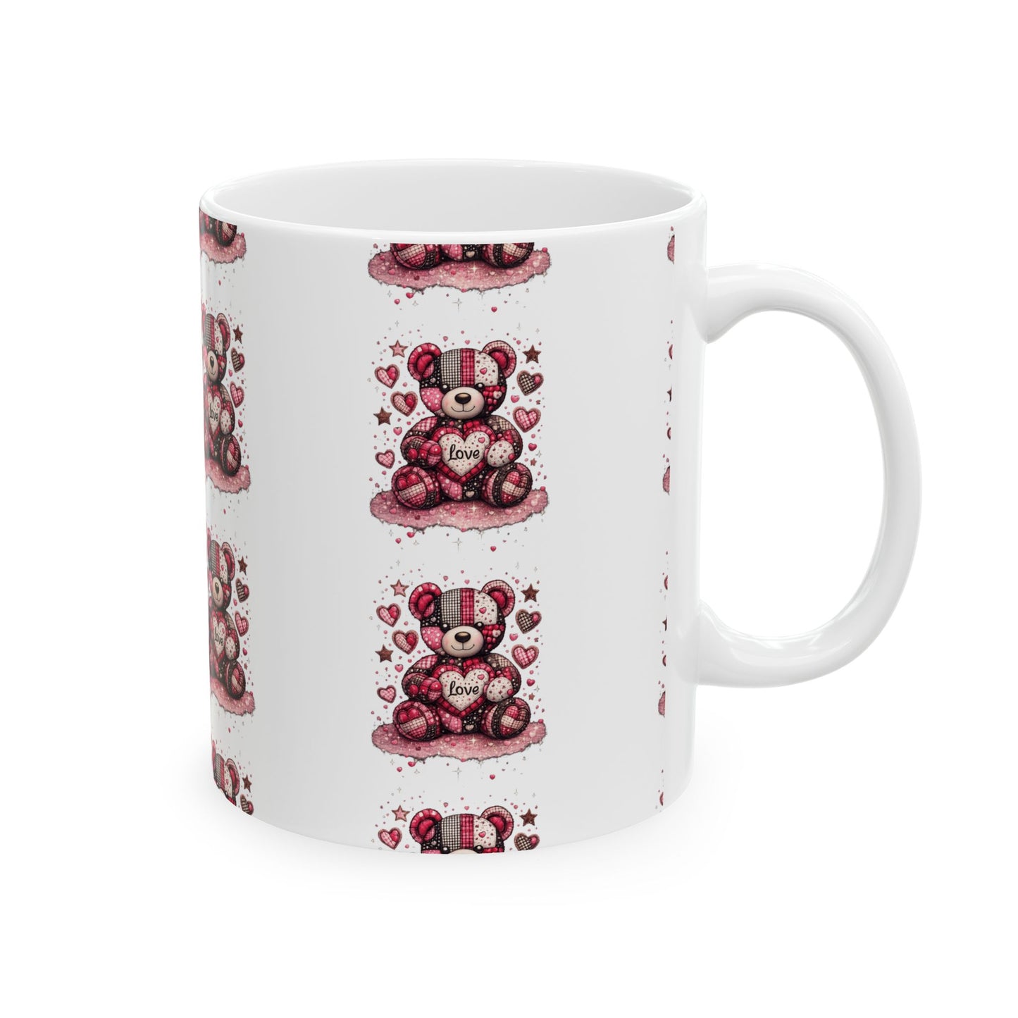 White ceramic coffee mug with a pink patchwork teddy bear holding a love heart design on a plain white background.